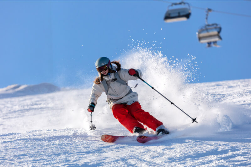 A winter sports enthusiast speeds her way through fresh power at a famous Colorado ski resort.
